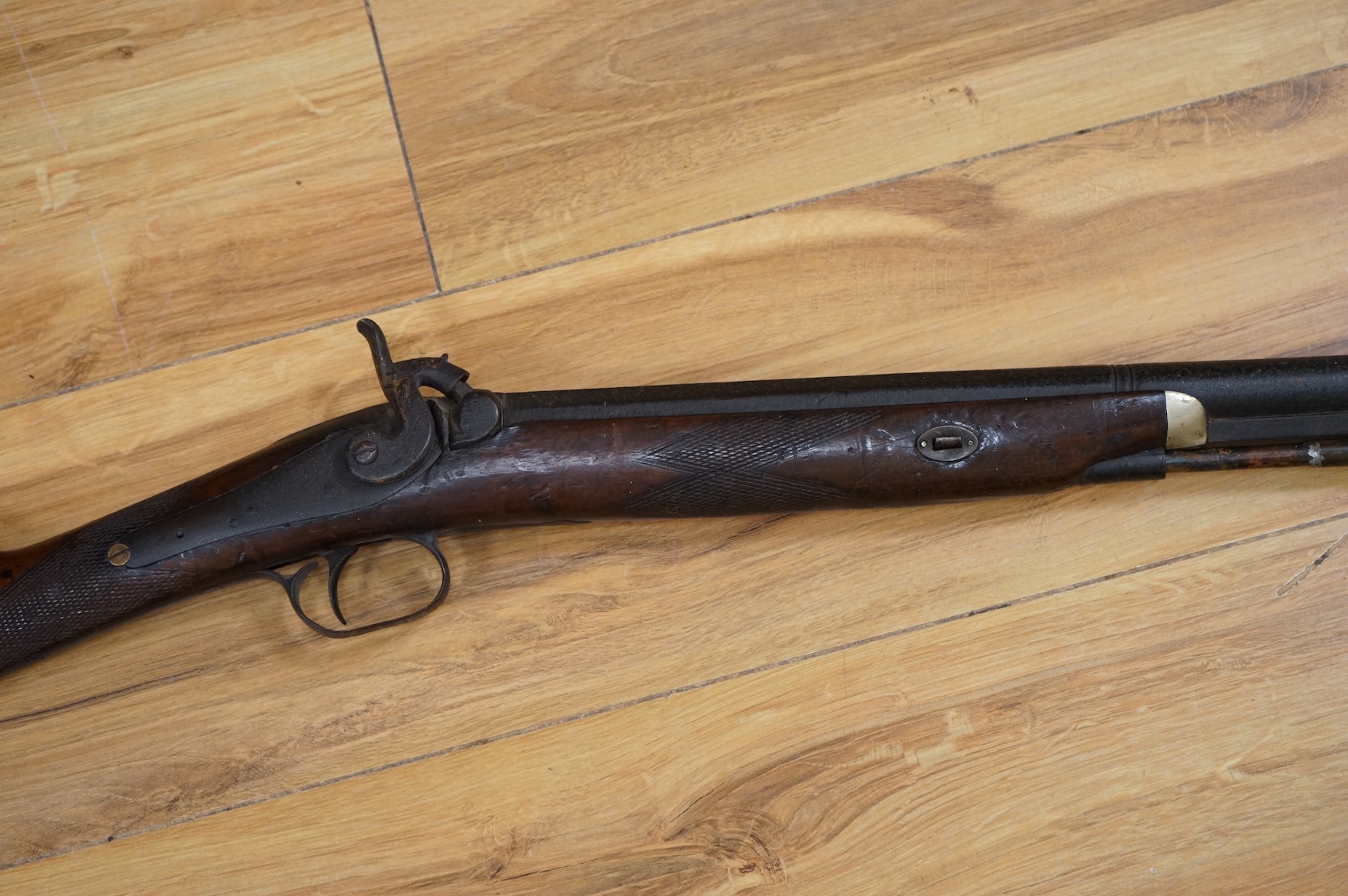 An English 16 bore back action, single barrel, percussion sporting gun, with half octagonal barrel half-stocked, barrel 82cm, iron mounted, chequered grip and fore end